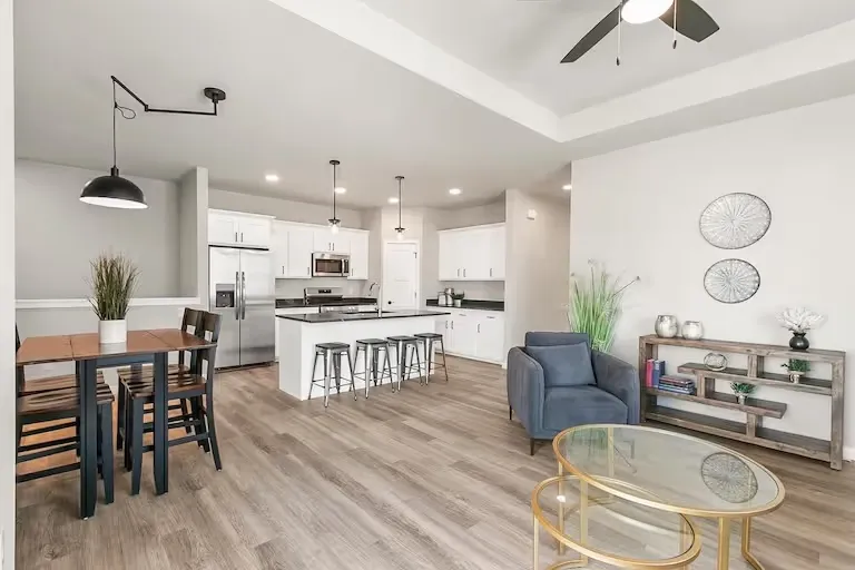 Open living and dining area with large windows in a representative Wild Oak ranch interior