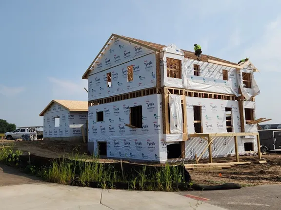 Workers framing the roof of the first Phase 1 townhouse building